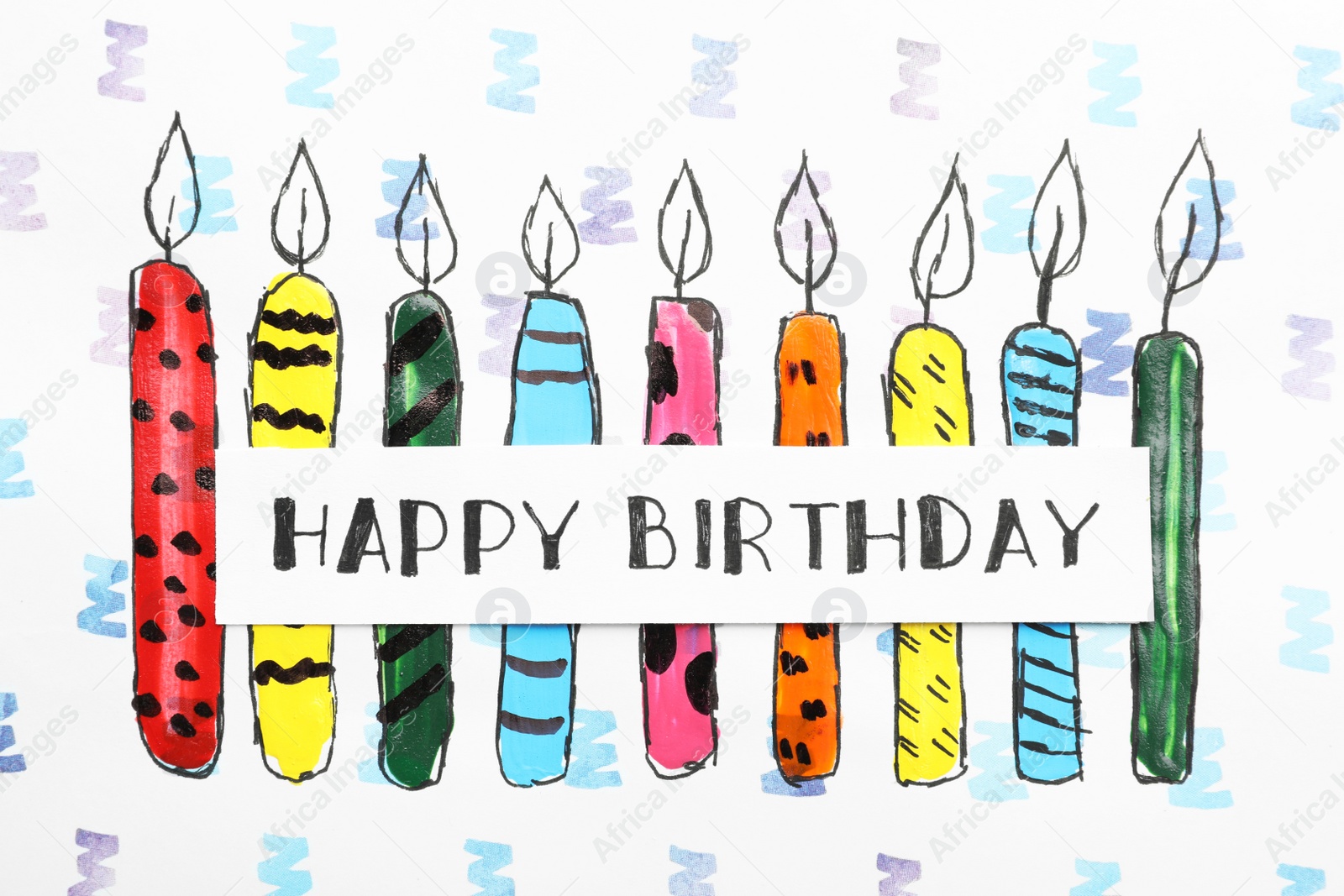 Photo of Card with words HAPPY BIRTHDAY and colorful drawn candles on paper sheet, top view