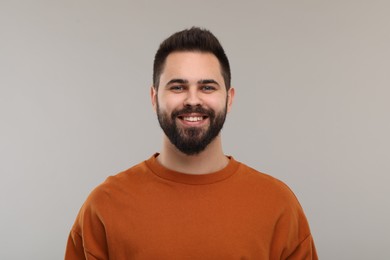 Photo of Man with clean teeth smiling on gray background