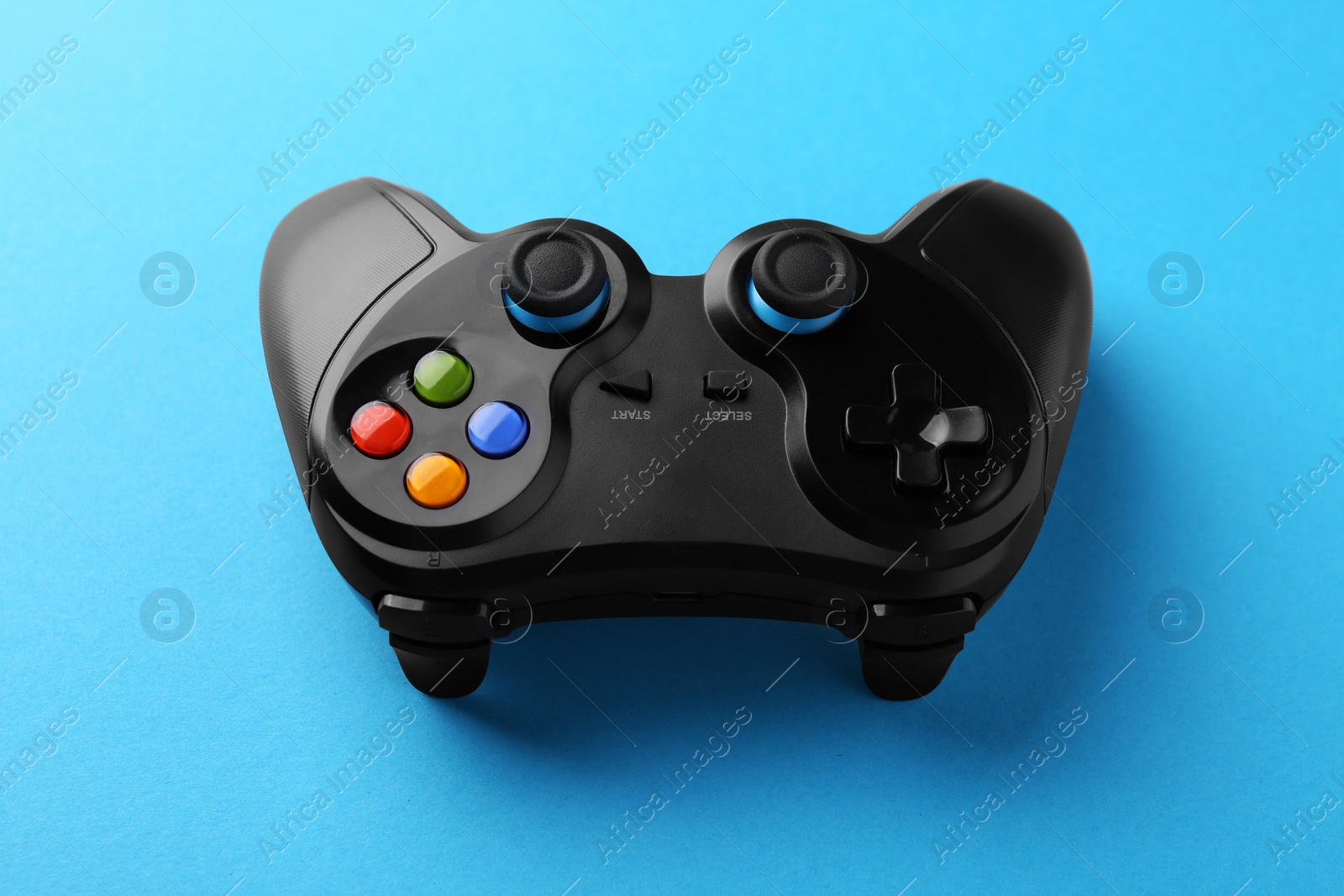 Photo of Wireless game controller on light blue background