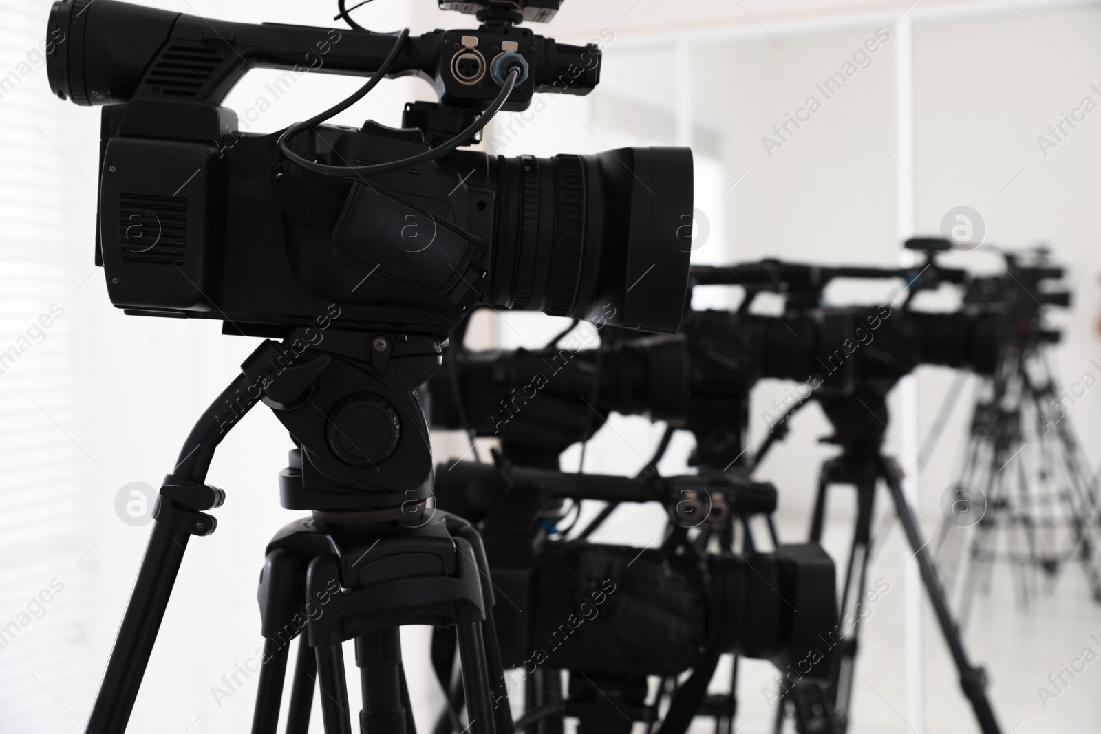 Photo of Modern video cameras indoors. Professional media equipment for broadcasting event