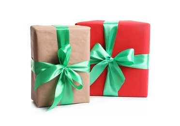 Photo of Beautifully wrapped gift boxes on white background