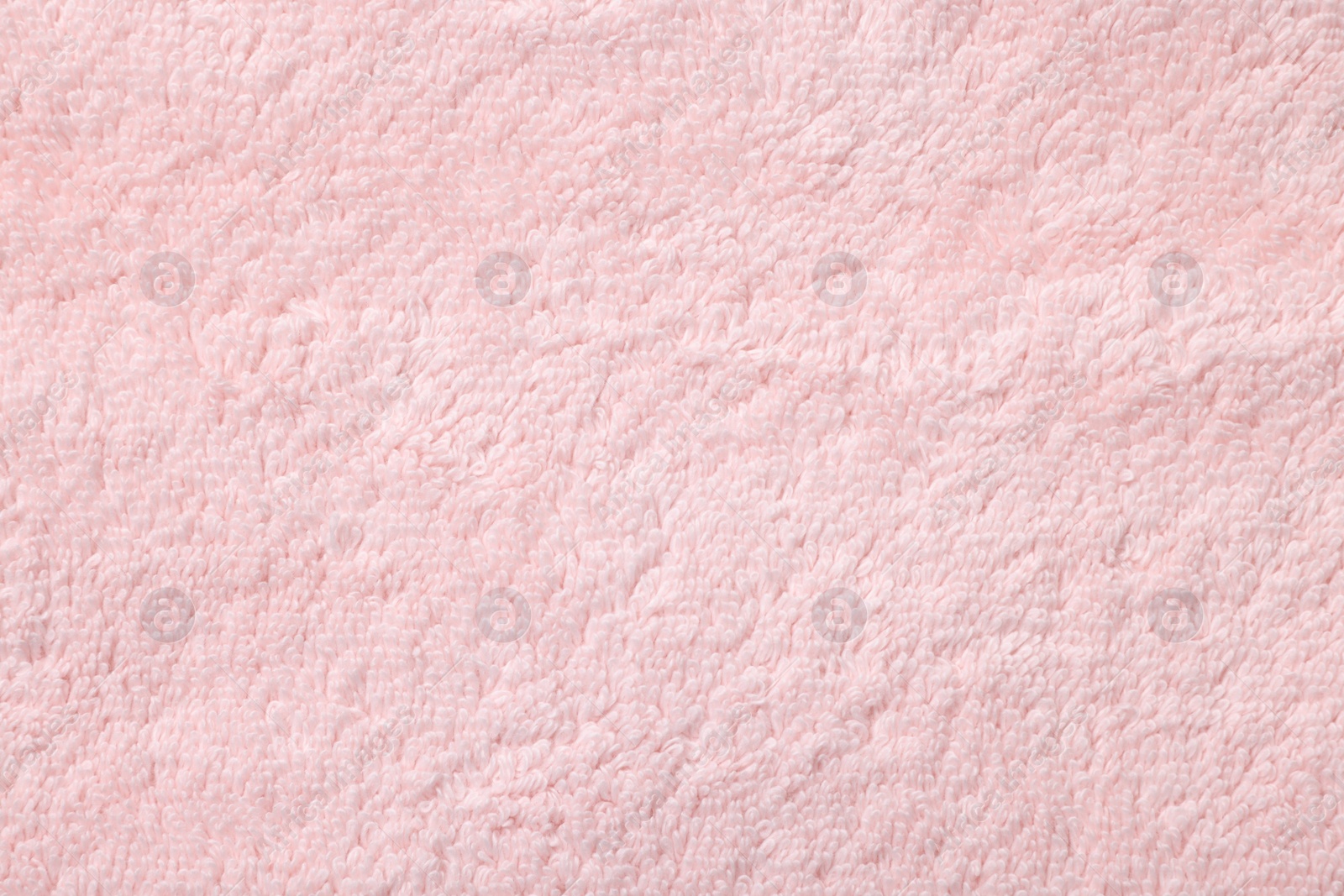 Photo of Texture of soft pink fabric as background, top view