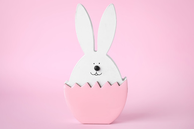 Photo of Bunny figure as Easter decor on pink background