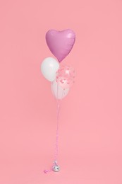 Bunch of heart and round shaped balloons for birthday party on pink background