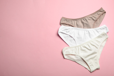 Photo of Women's underwear on pink background, flat lay. Space for text