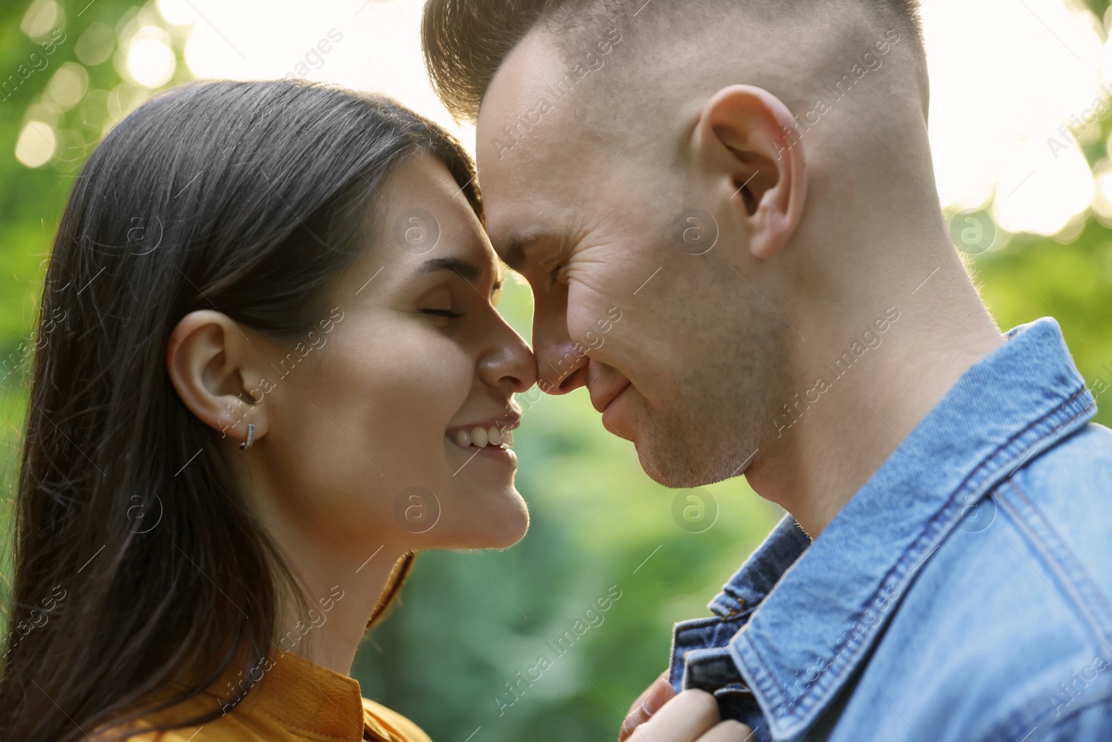 Photo of Affectionate young couple having good time together outdoors, closeup