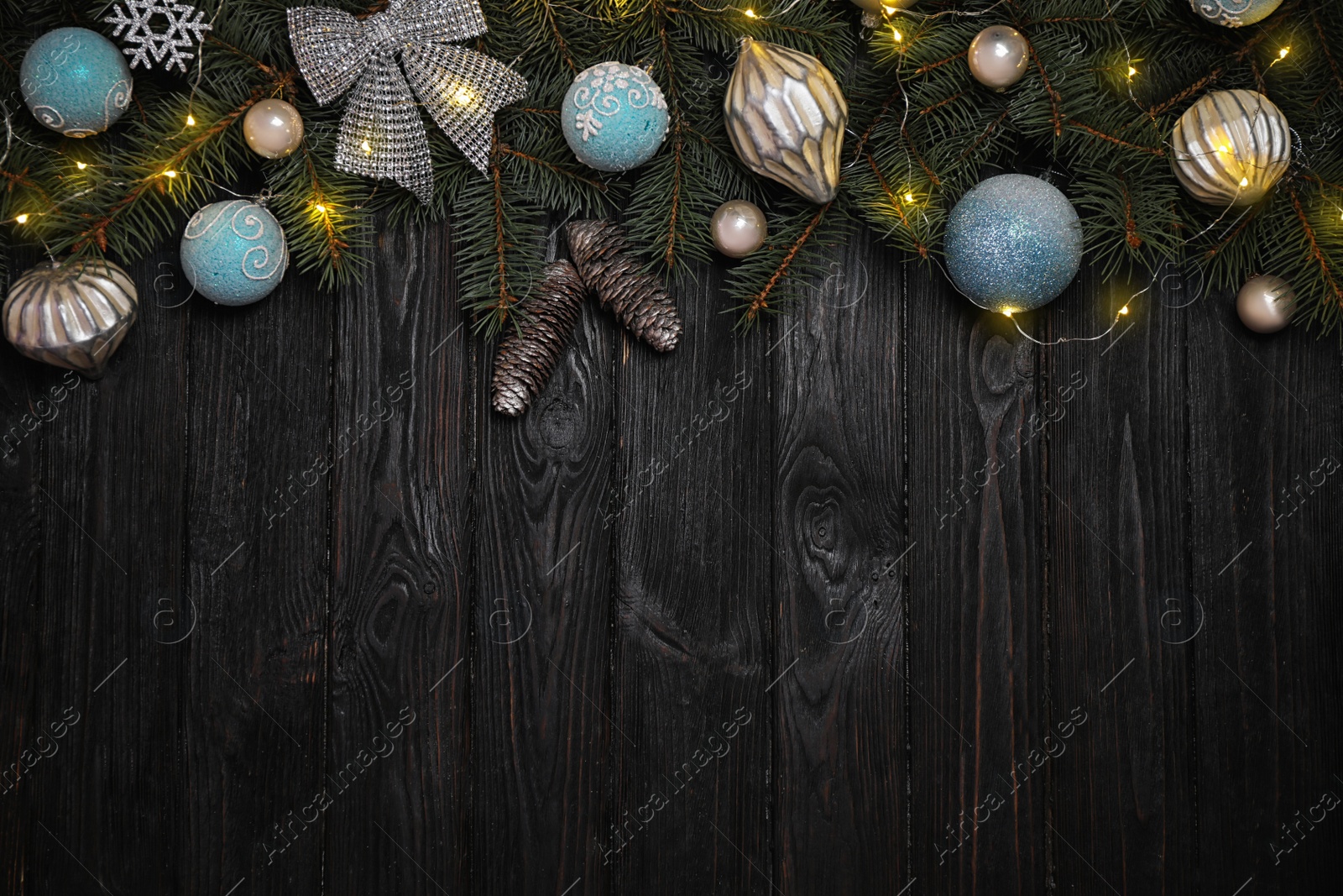 Photo of Christmas decoration on black wooden background, flat lay. Space for text