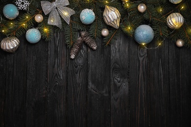 Christmas decoration on black wooden background, flat lay. Space for text