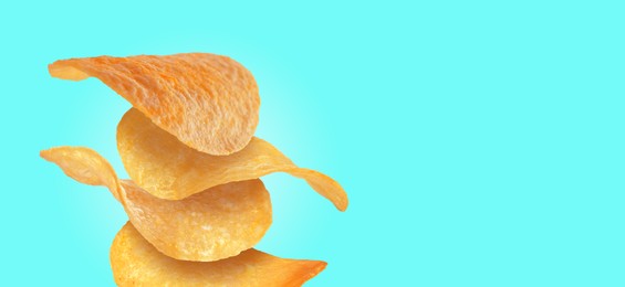 Image of Stack of tasty potato chips on cyan background, space for text