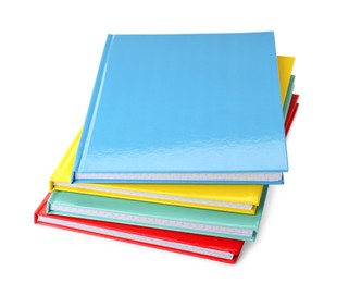 Stack of different colorful hardcover planners on white background