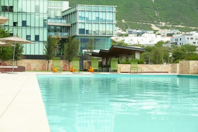 Photo of Outdoor swimming pool, hotel and beautiful mountain on background