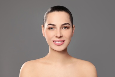 Portrait of young woman with beautiful face and natural makeup on color background