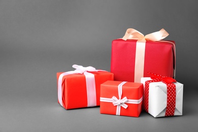 Photo of Beautiful gift boxes with ribbons on gray background