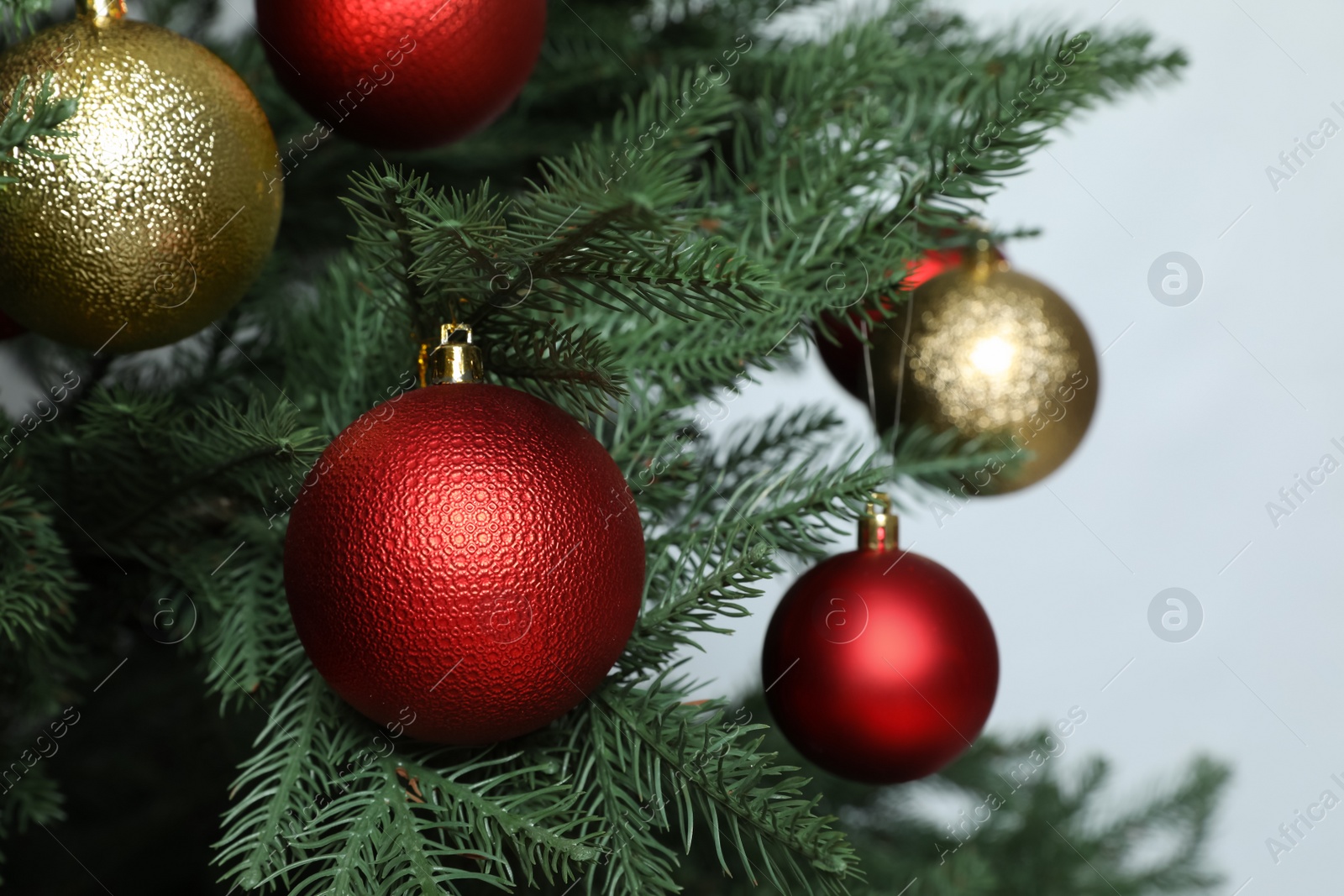Photo of Beautiful Christmas tree with shiny baubles on white background, closeup