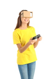 Young woman using cardboard virtual reality headset, isolated on white