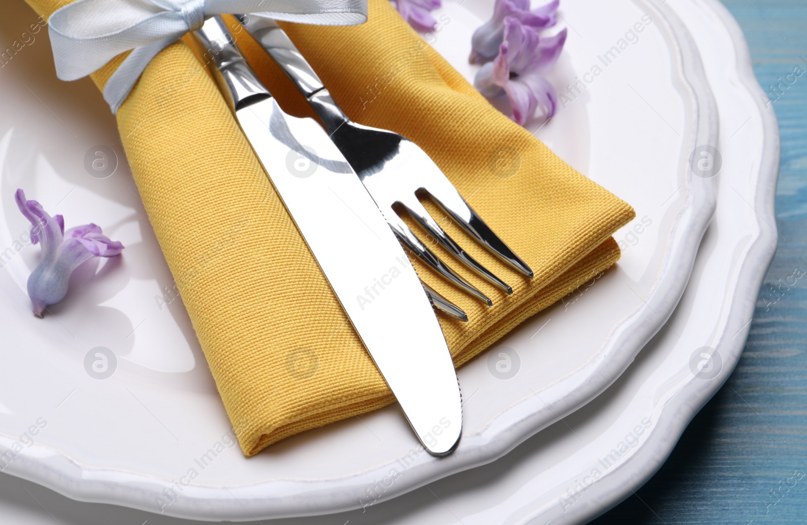 Photo of Festive Easter table setting on blue background, closeup