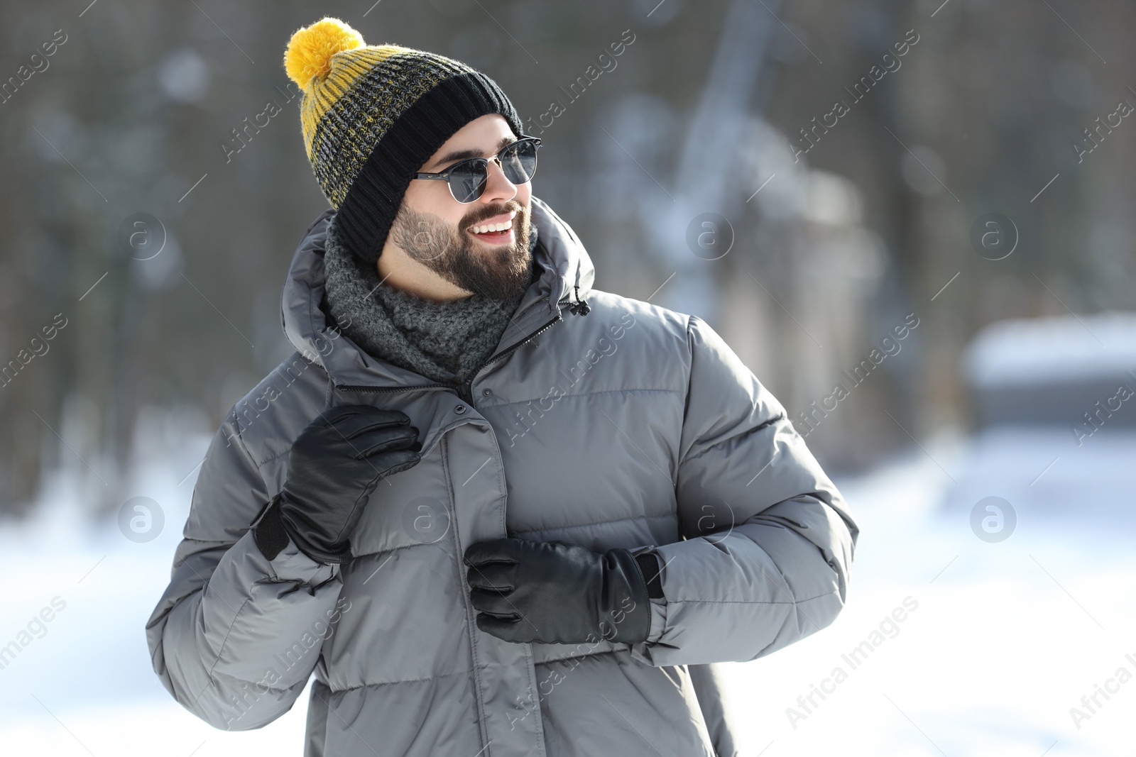 Photo of Portrait of handsome young man with sunglasses on winter day outdoors