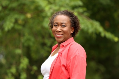 Portrait of happy African-American woman in park