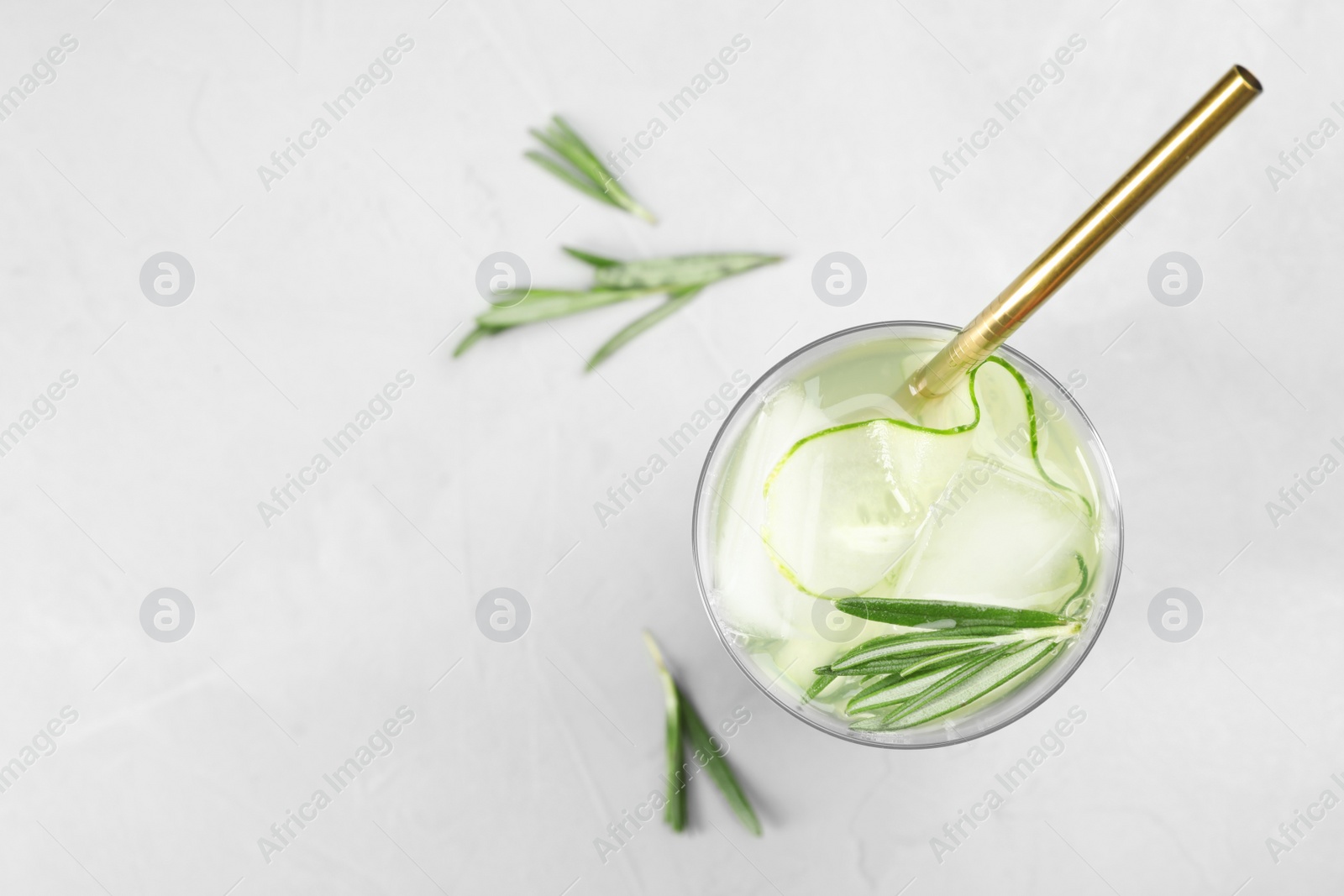 Photo of Glass of refreshing cucumber lemonade on table, top view with space for text. Summer drink