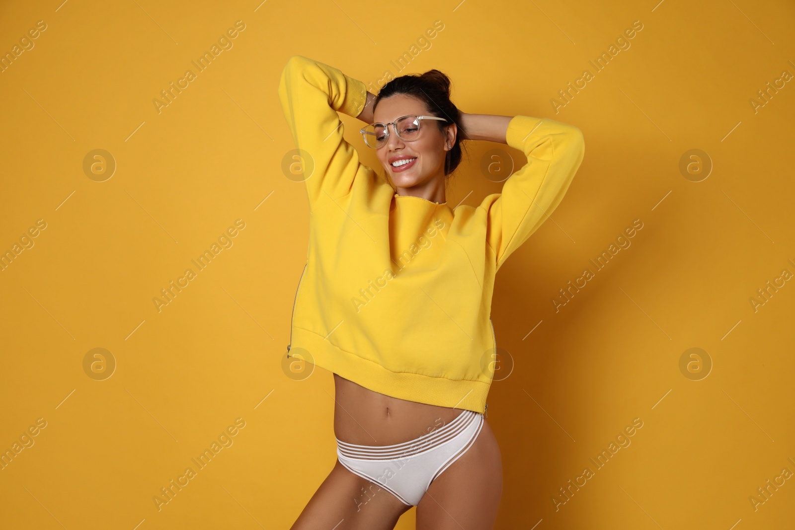 Photo of Beautiful woman in white panties on yellow background