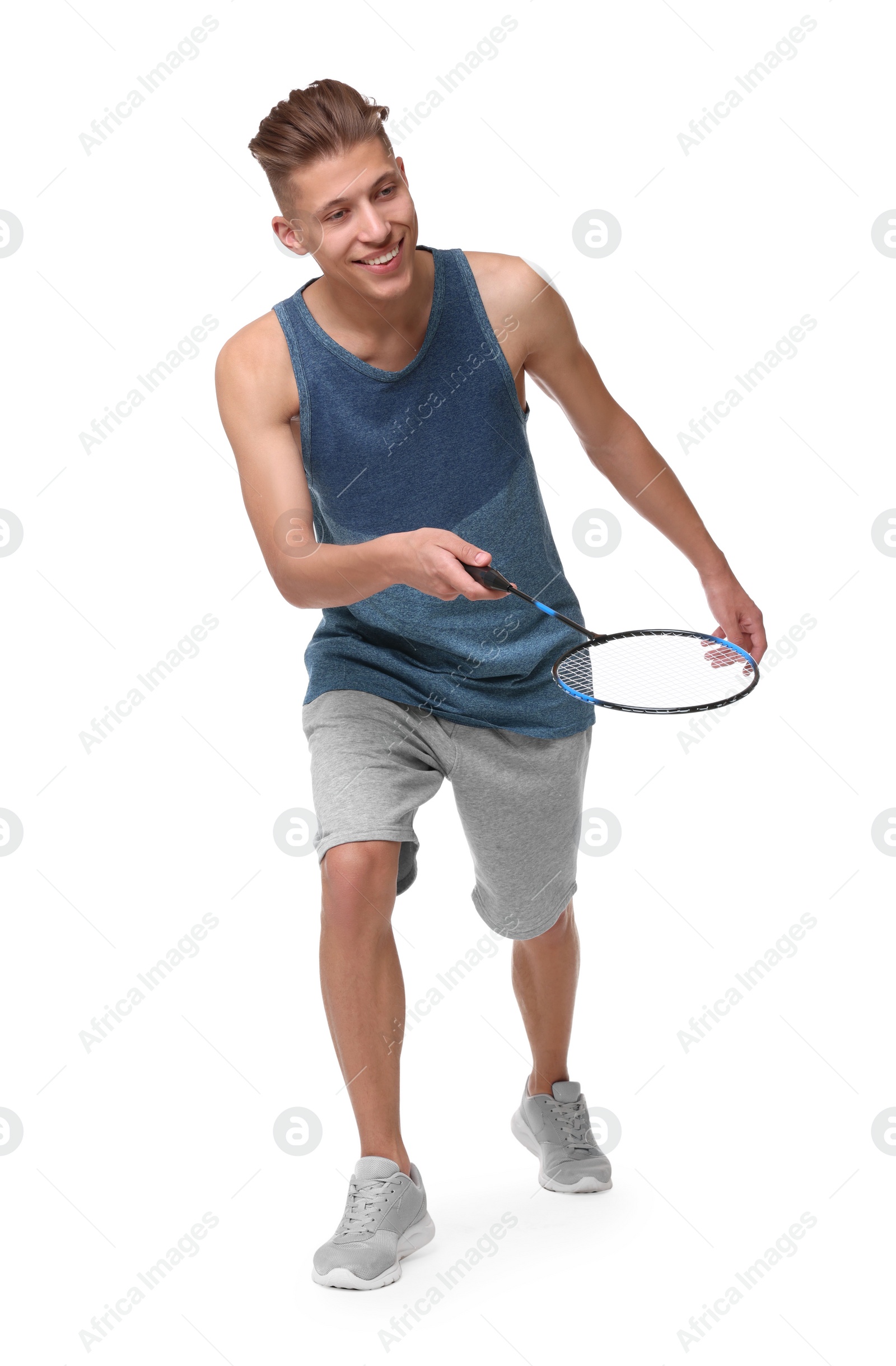 Photo of Young man playing badminton with racket on white background