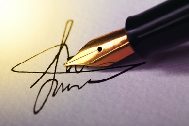 Image of Signing on sheet of paper with fountain pen, closeup