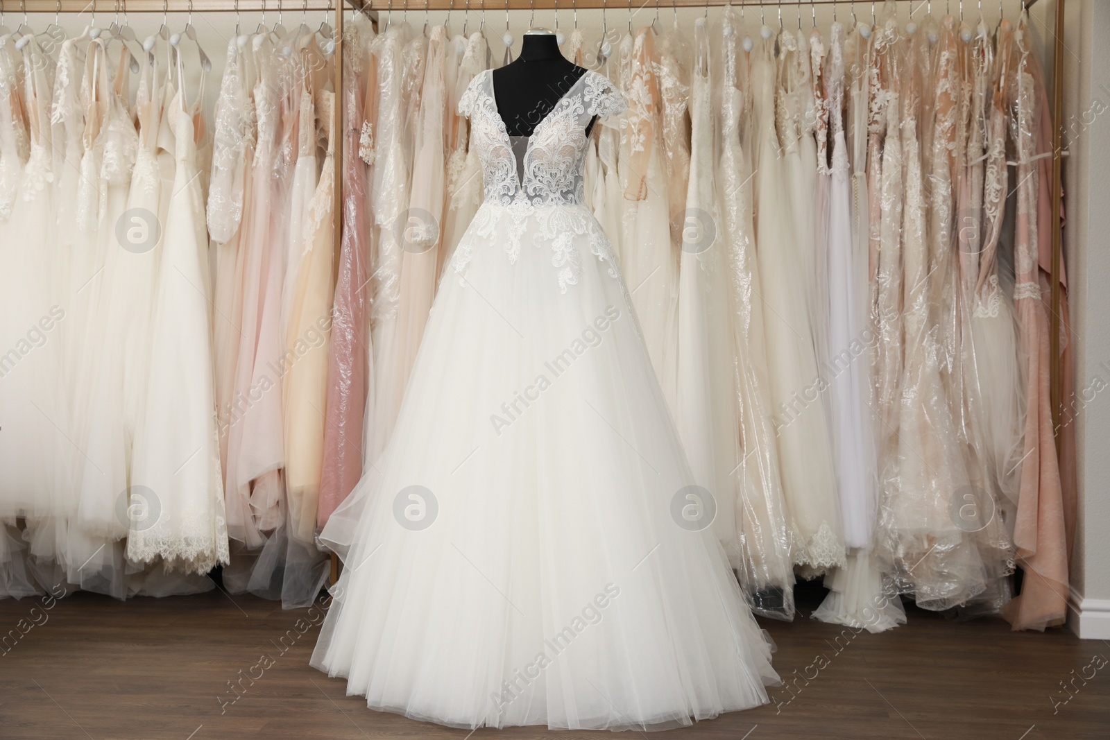 Photo of Beautiful wedding dress on mannequin in boutique