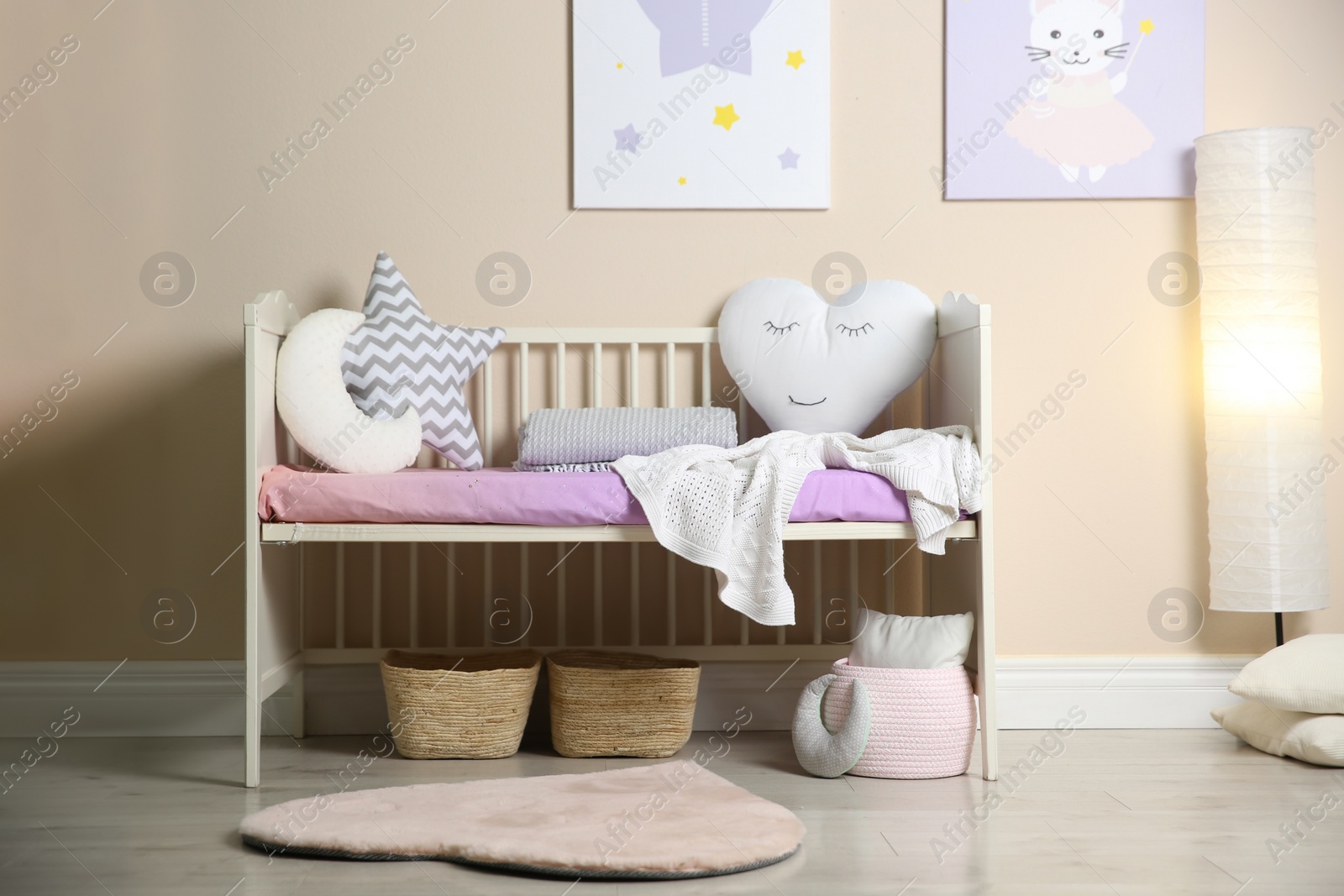 Photo of Cute baby room interior with modern crib and toys