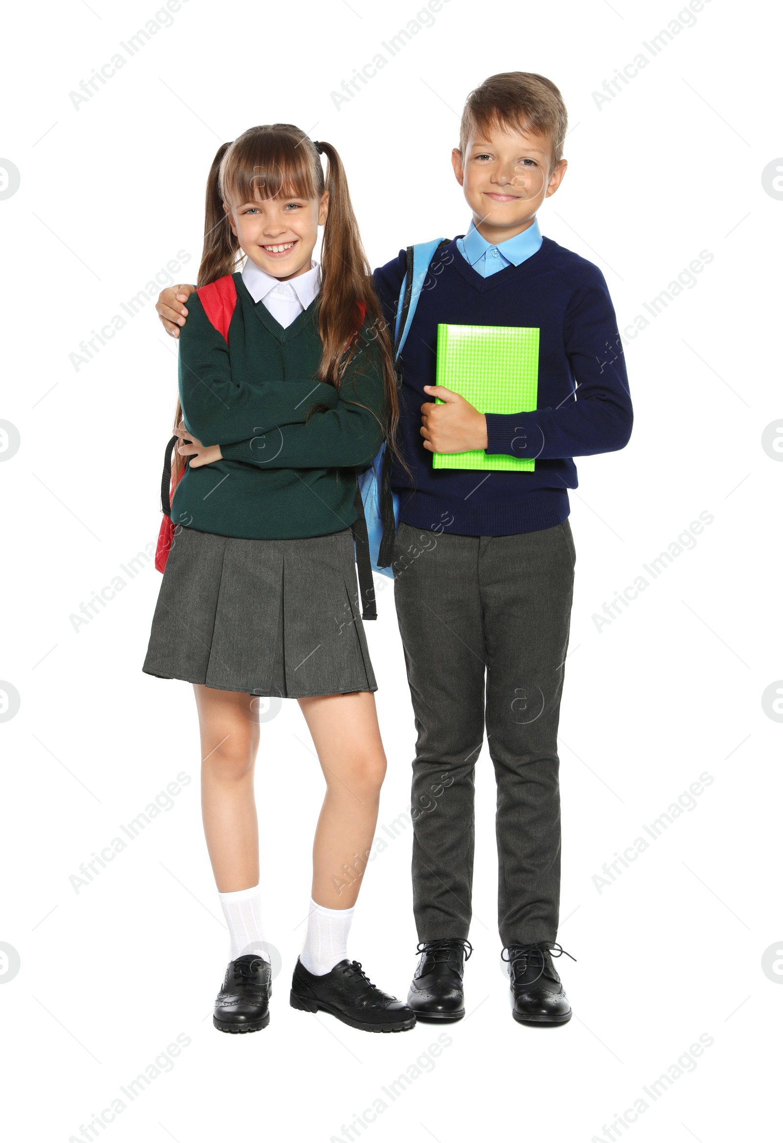 Photo of Little children in stylish school uniform on white background