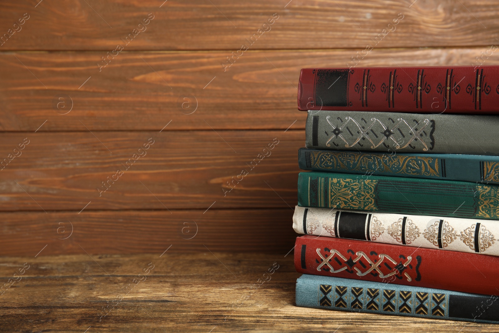 Photo of Collection of old books on wooden shelf. Space for text