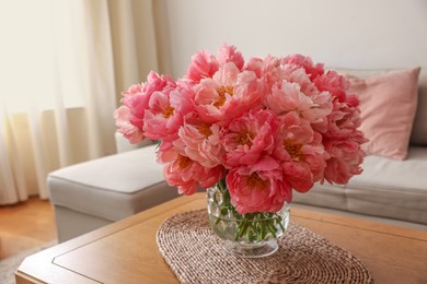 Beautiful pink peonies in vase on table at home. Interior design