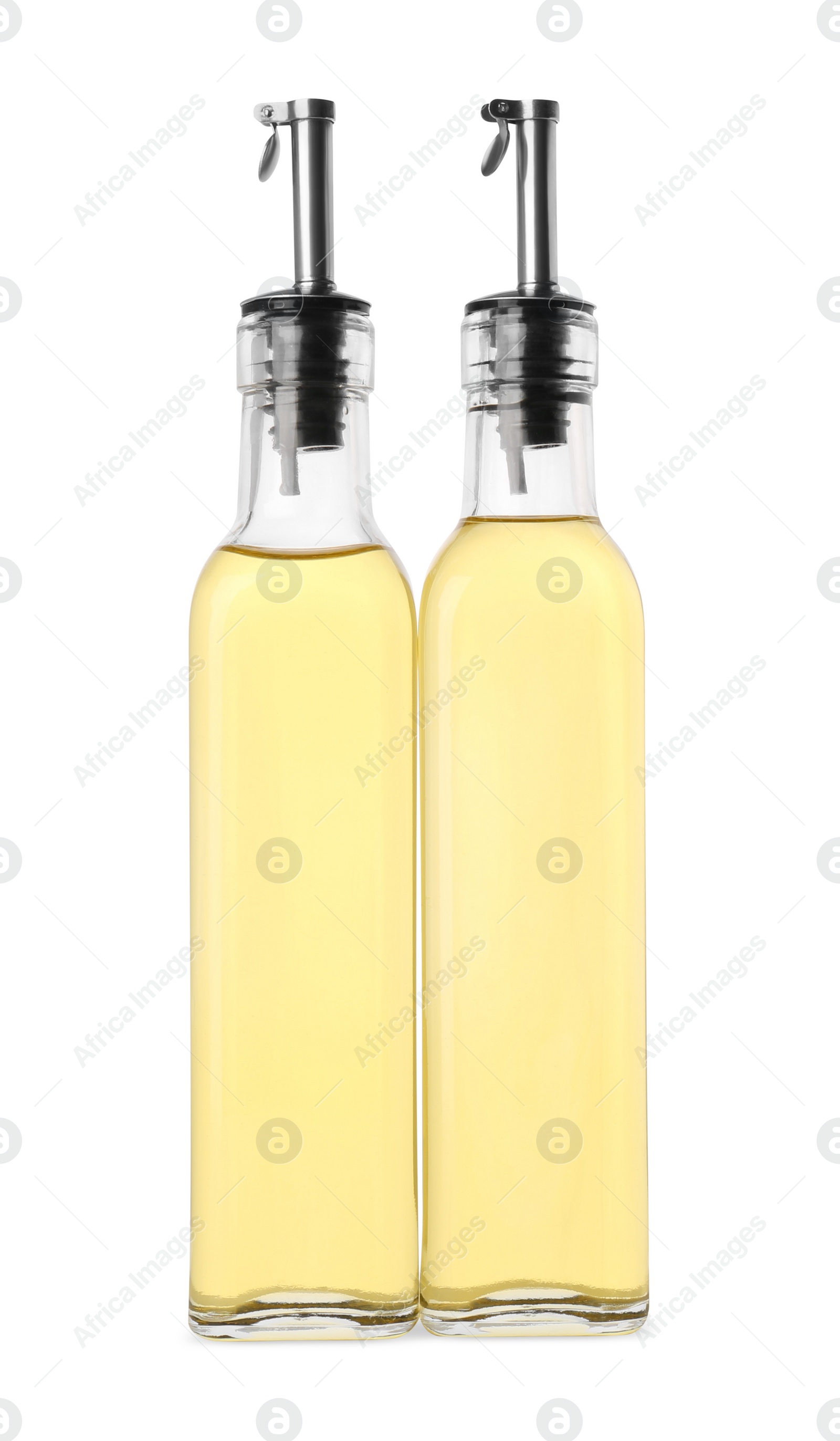 Photo of Glass bottles of cooking oil on white background