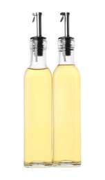 Photo of Glass bottles of cooking oil on white background