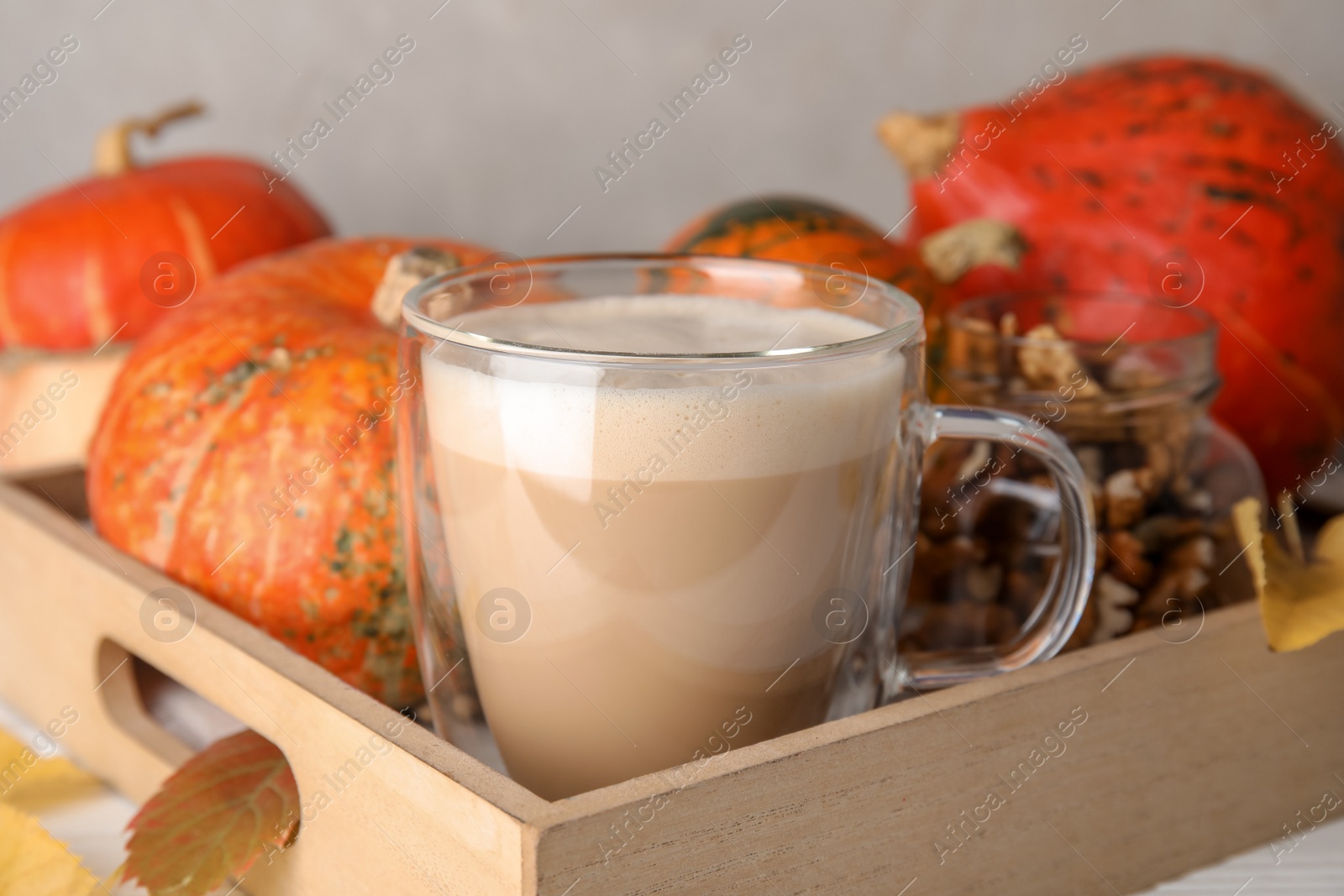 Photo of Composition with cup of tasty pumpkin spice latte on table