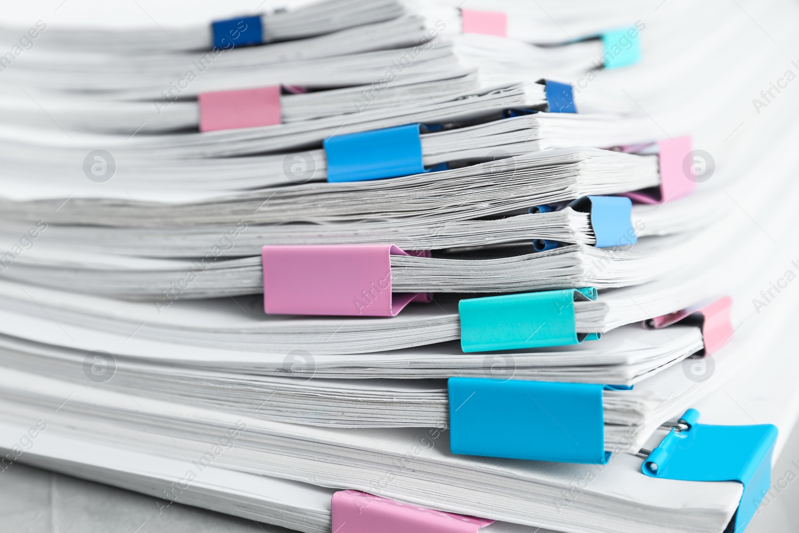 Photo of Stack of documents with binder clips, closeup