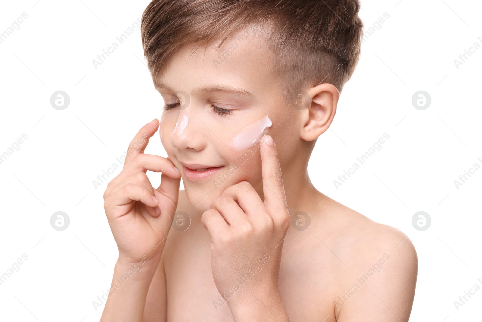 Photo of Happy boy applying sun protection cream onto his face against white background