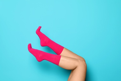 Photo of Woman wearing bright socks on color background