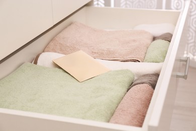 Photo of Scented sachet and folded towels in drawer