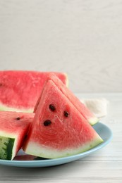 Photo of Delicious fresh watermelon slices on white wooden table