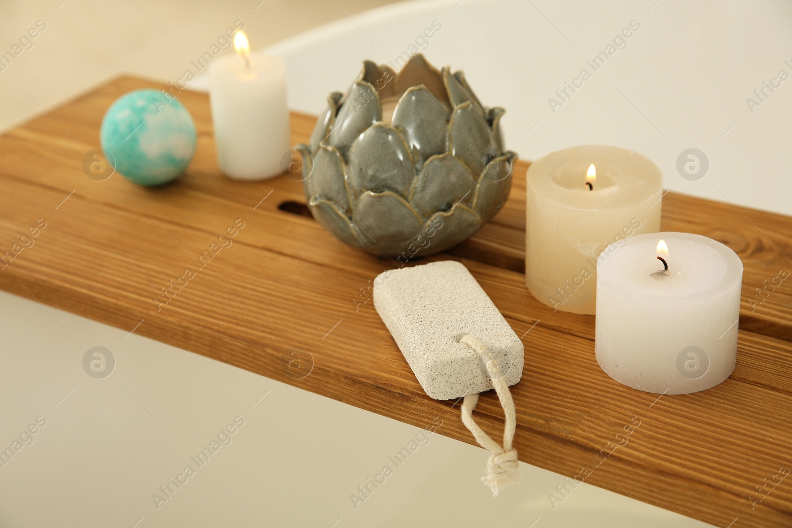 Photo of Pumice stone and decor on wooden caddy in bathroom