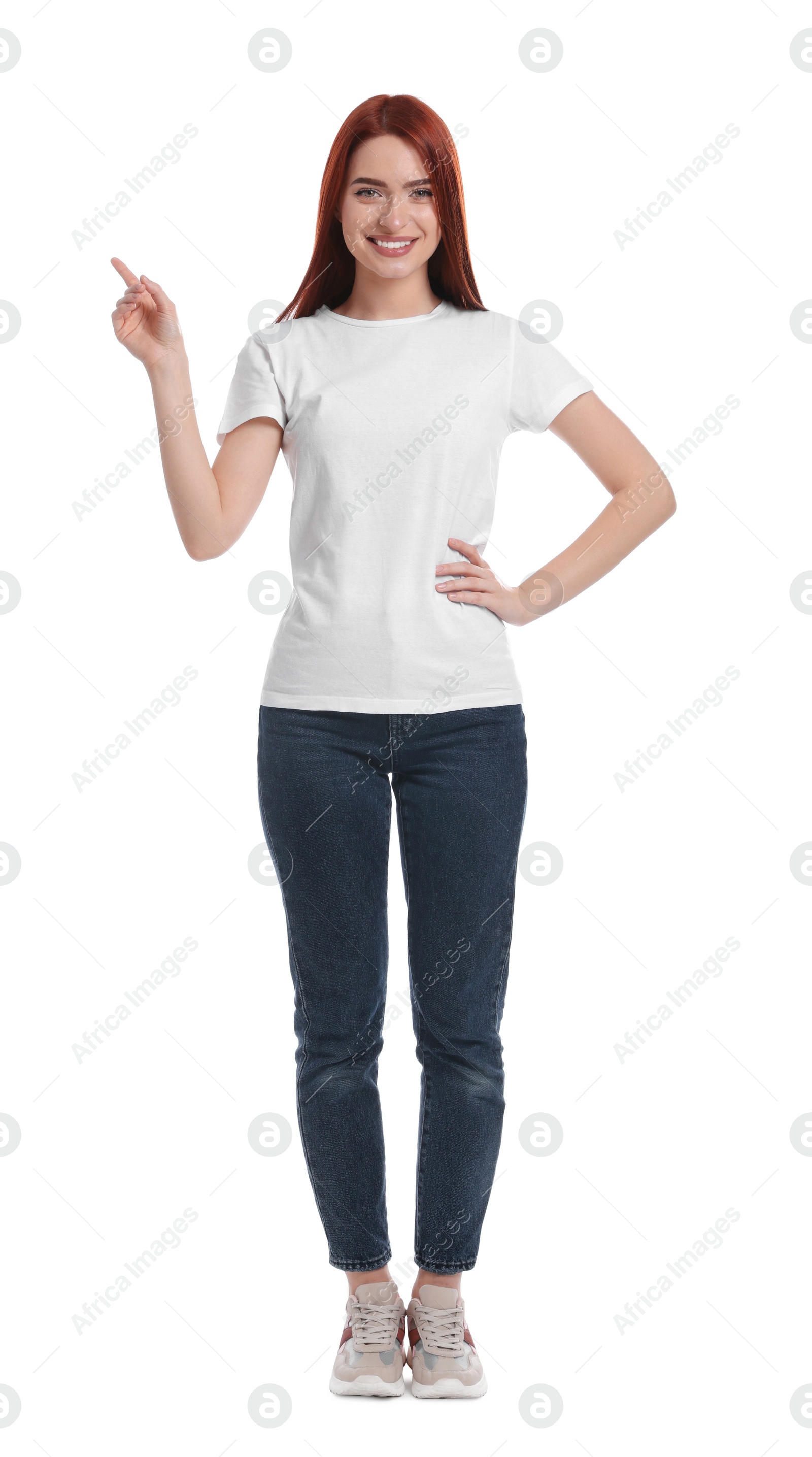 Photo of Happy woman with red dyed hair pointing somewhere on white background