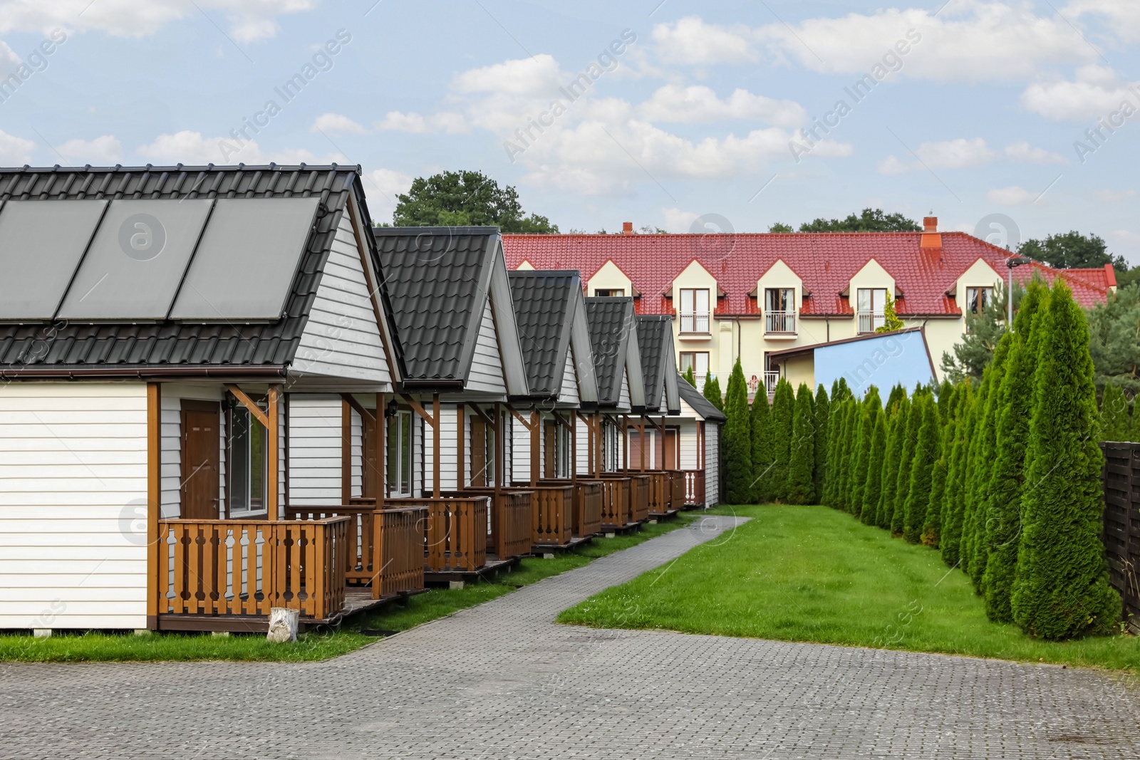 Photo of Beautiful wooden beach houses and green trees outdoors