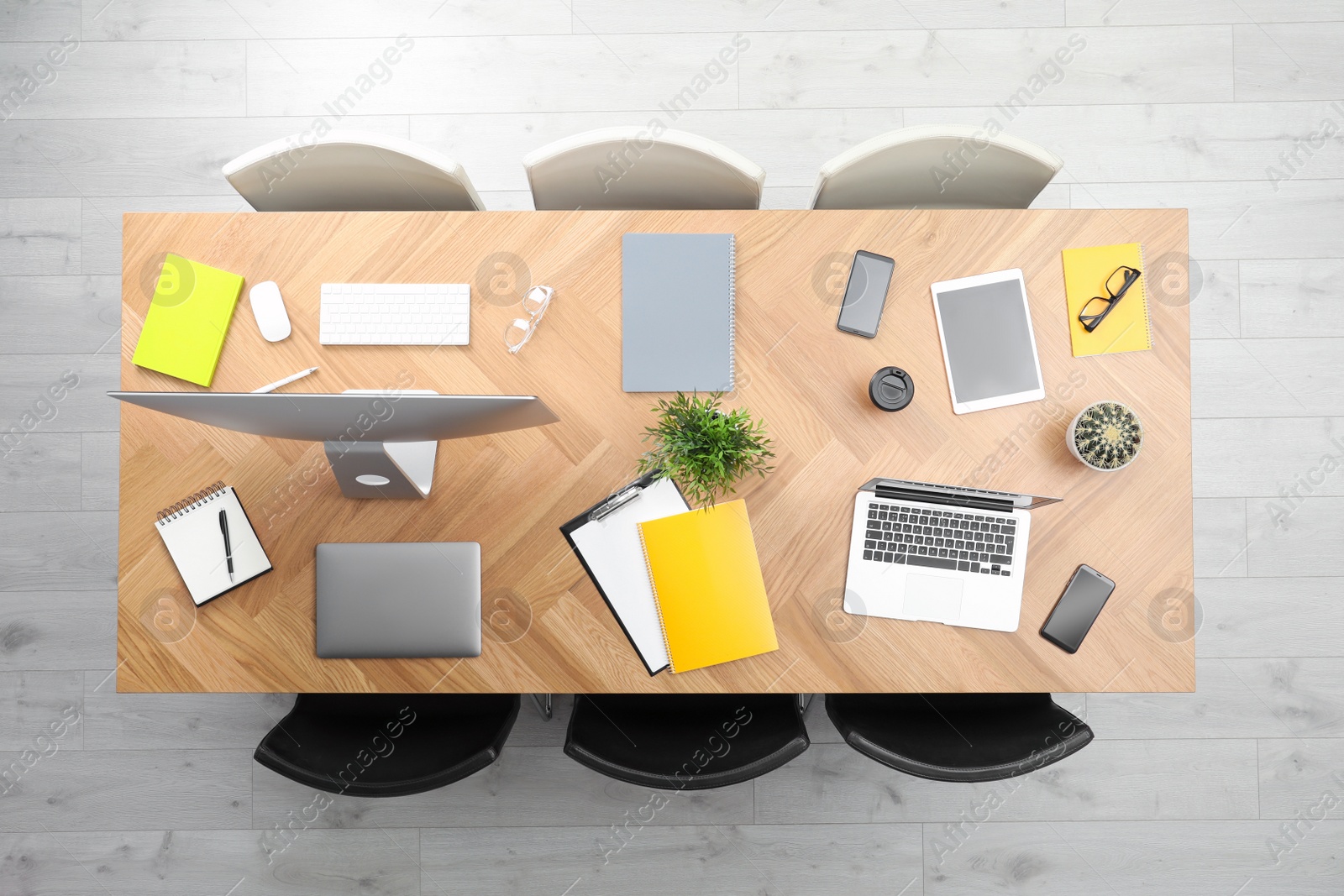 Photo of Modern office table with devices and chairs, top view