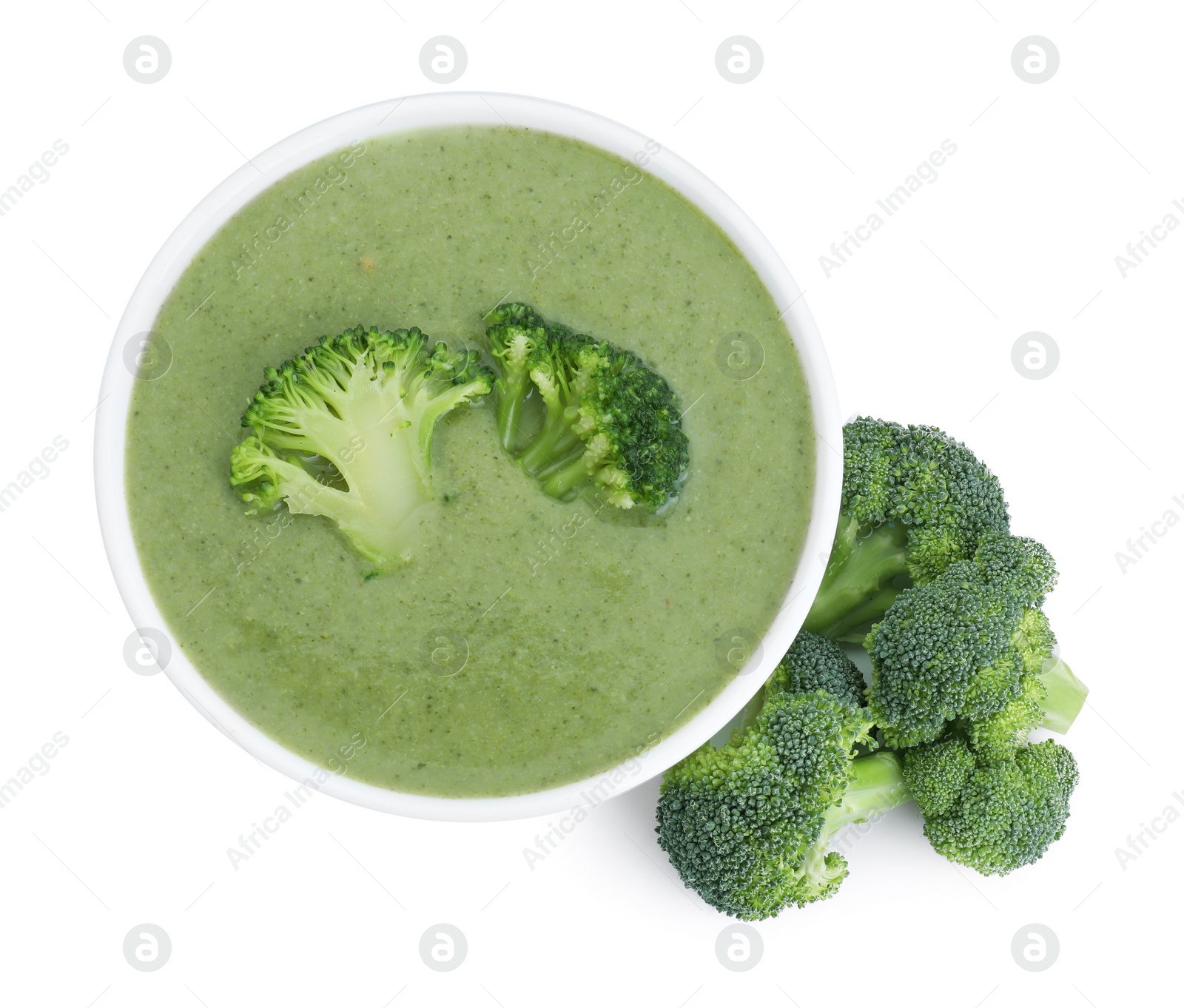 Photo of Delicious broccoli cream soup in bowl isolated on white, top view