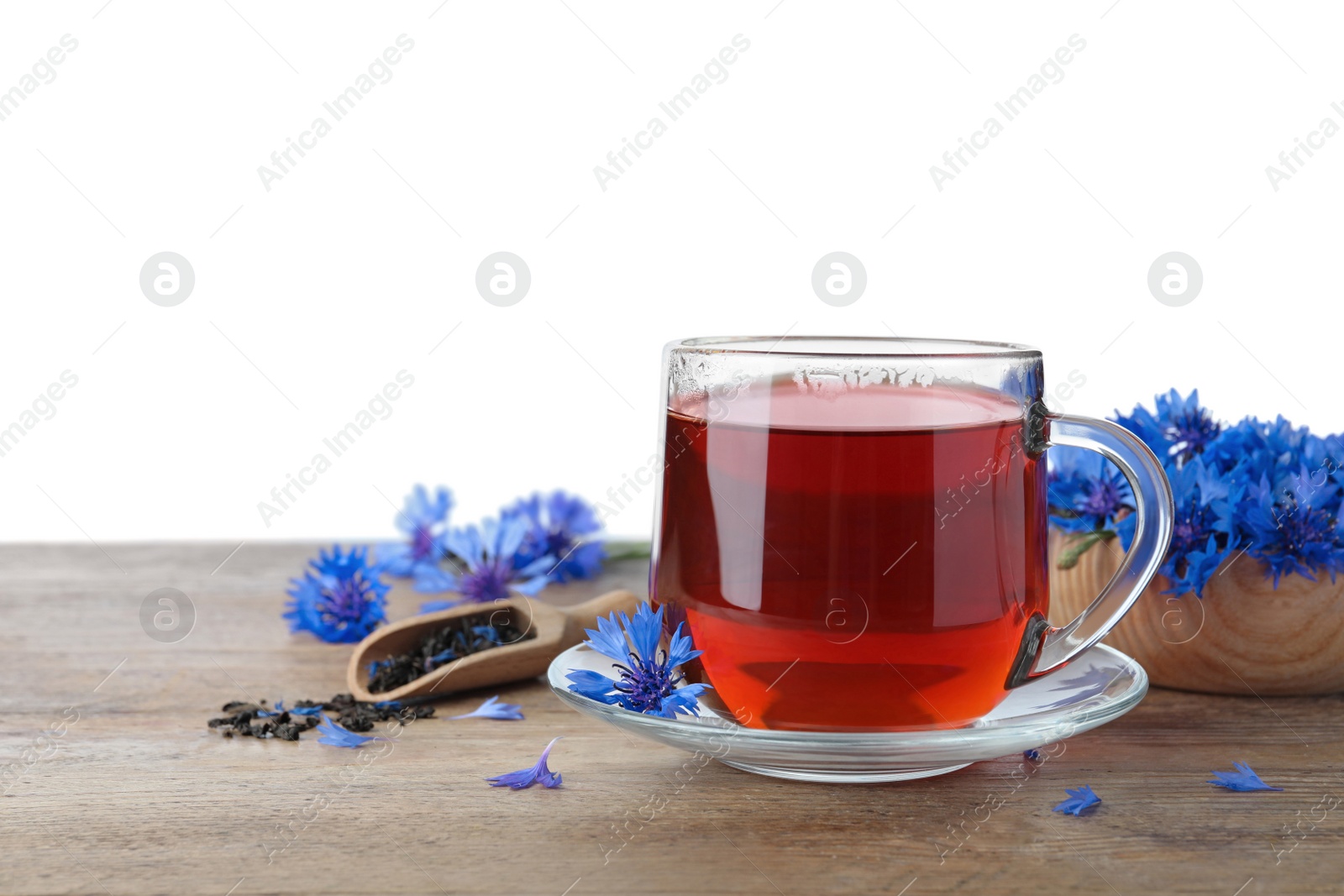 Photo of Cornflower tea and fresh flowers on wooden table