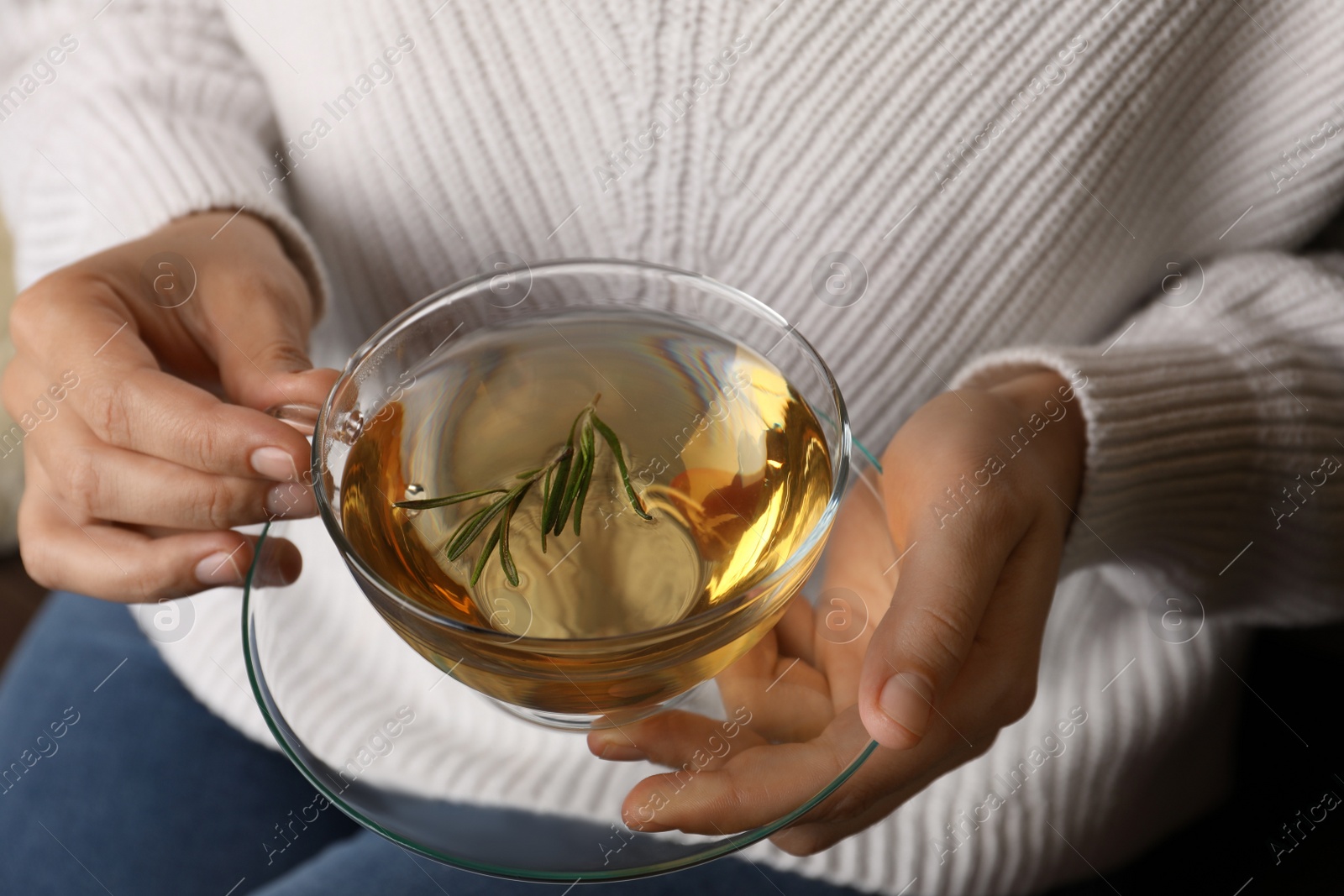 Photo of Woman drinking tasty herbal tea, closeup view