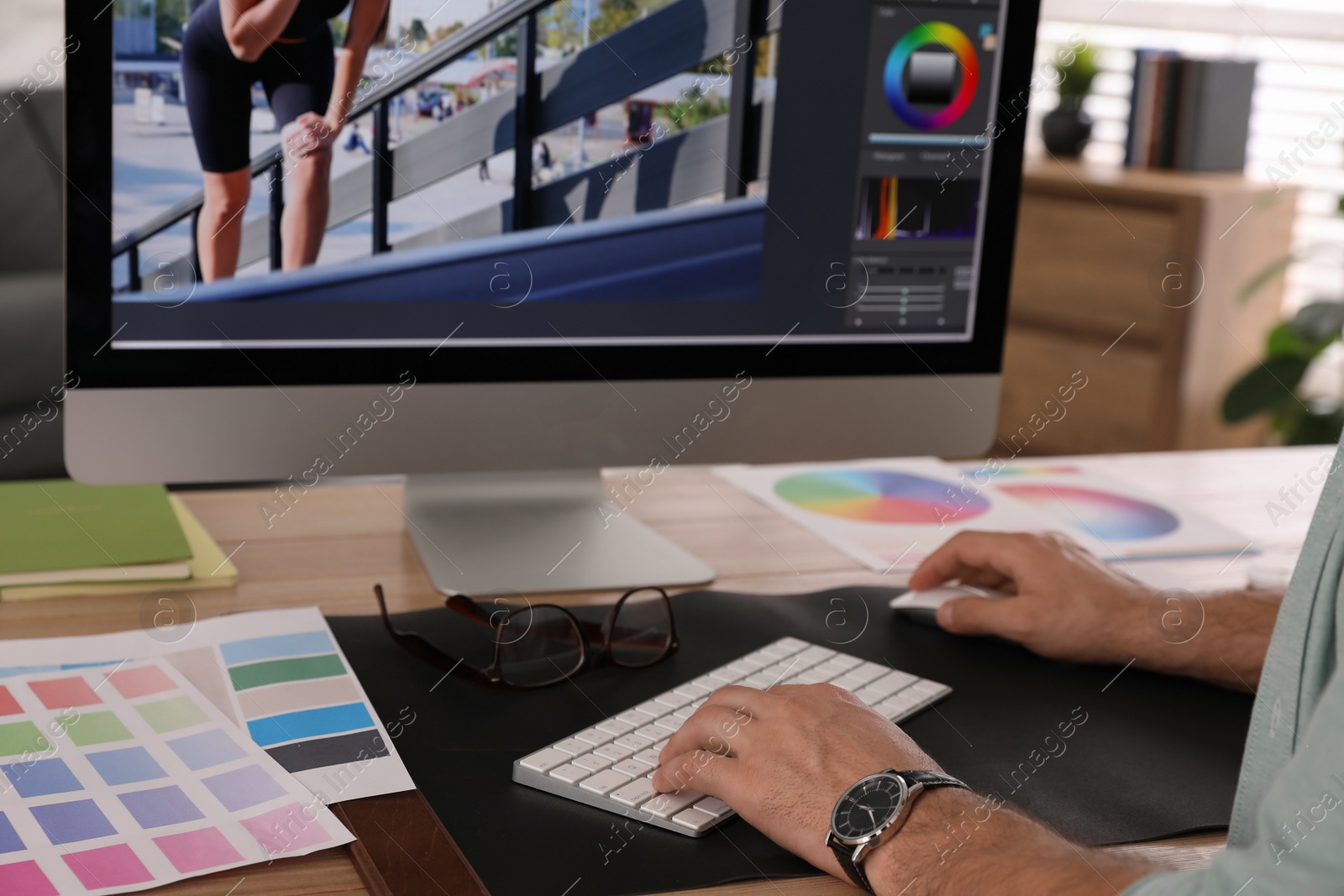 Photo of Professional retoucher working on computer in office, closeup