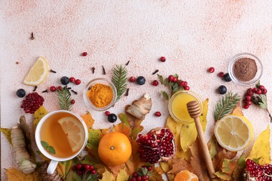 Photo of Flat lay composition with cup of delicious immunity boosting tea and ingredients on color textured background. Space for text