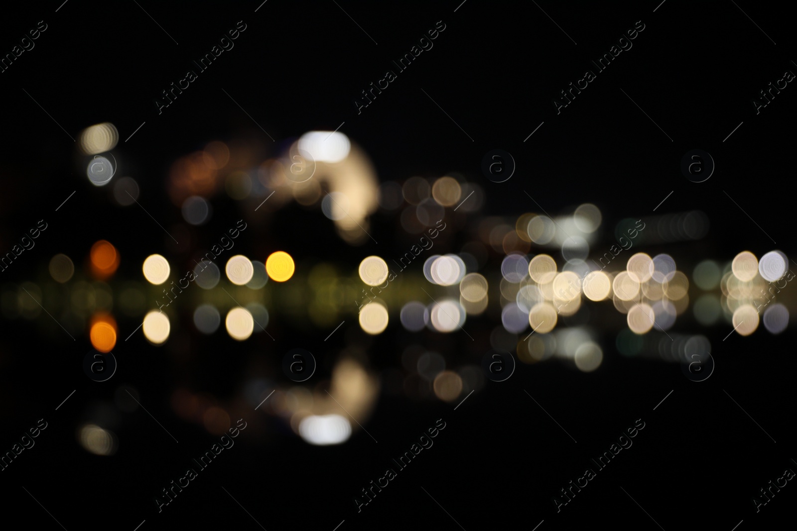 Photo of Blurred view of city street with lights at night. Bokeh effect