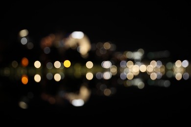 Blurred view of city street with lights at night. Bokeh effect